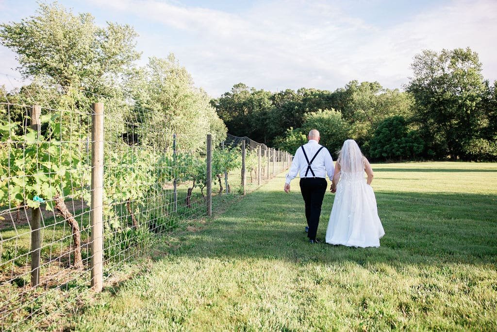 bride and groom walking in vineyards at Winemakers Ballroom in South Jersey