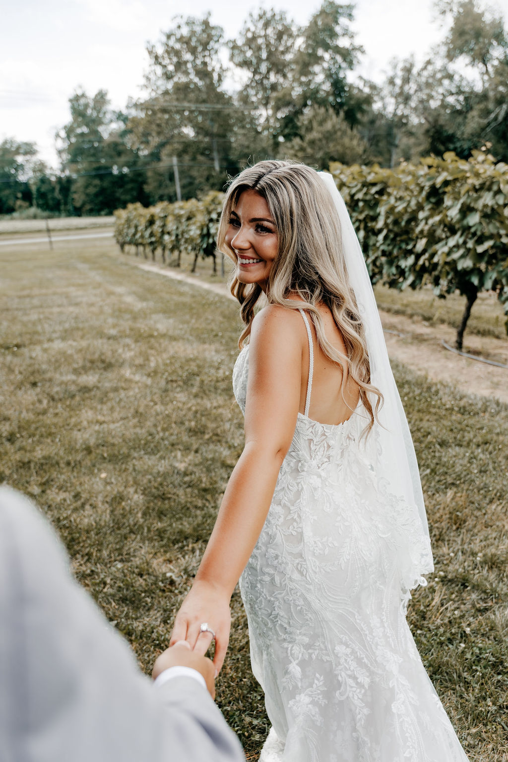 Bride taking wedding day pic in vineyard in Burlington County NJ
